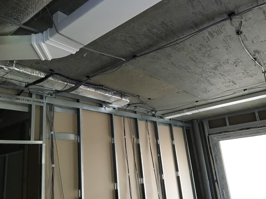 MVHR ductwork installation along soffit during fit-out