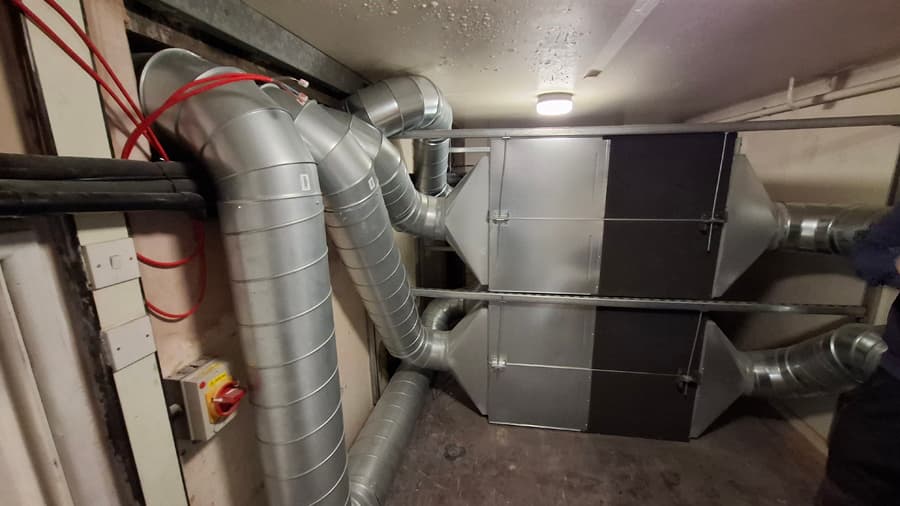 MVHR heat recovery unit installed in plant room with spiral ductwork