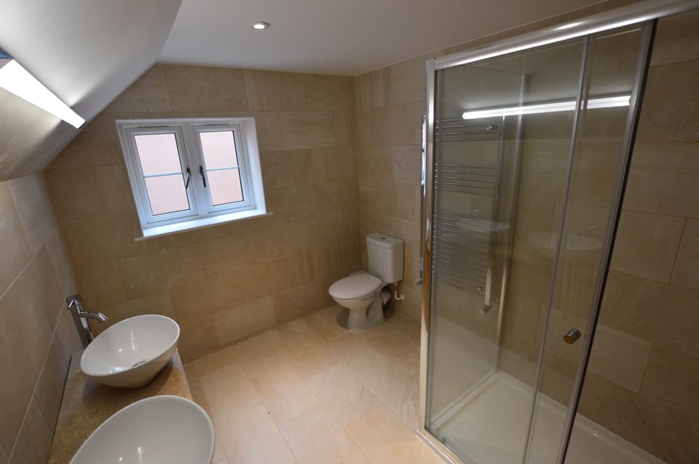 Loft conversion bathroom with shower enclosure and dual basins