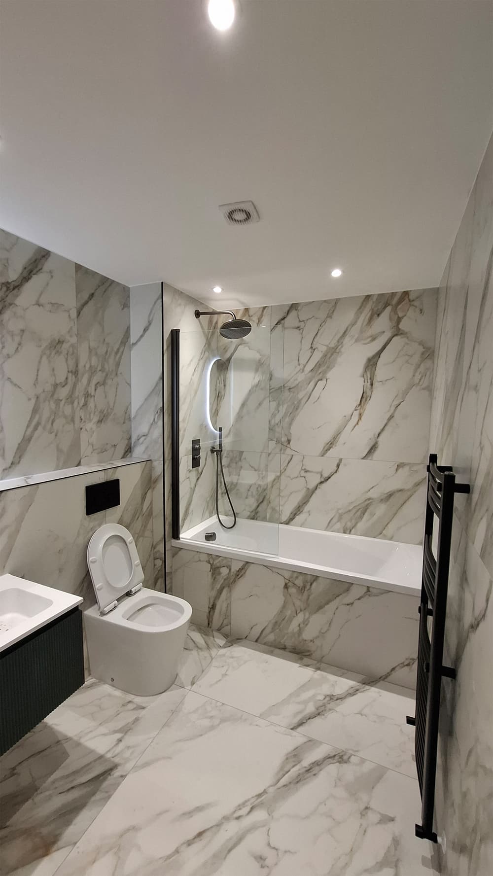 Premium marble bathroom installation in Kent with rainfall shower and freestanding bath