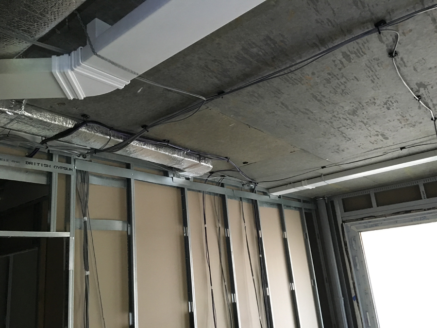 MVHR ductwork installation along soffit during fit-out