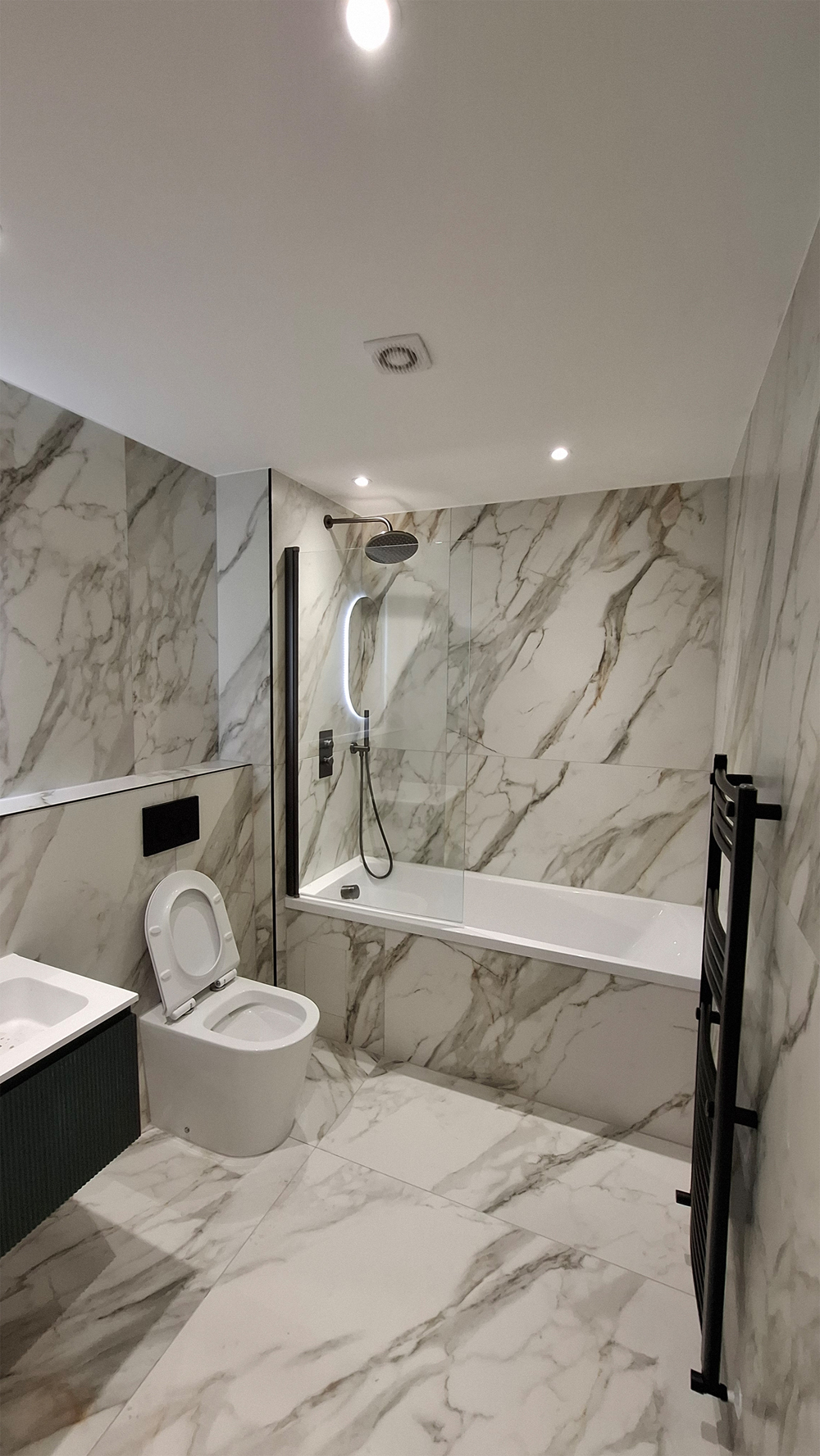 Premium marble bathroom installation in Kent with rainfall shower and freestanding bath
