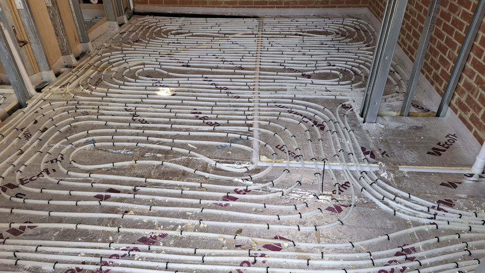 Wet underfloor heating pipework laid out before screed